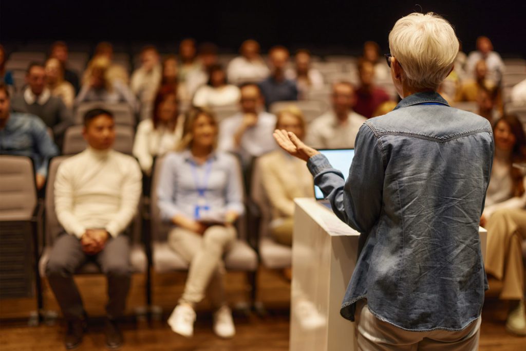 Lady at podium delivering a speech